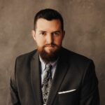 a man with a beard wearing a suit and tie.