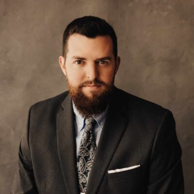 a man with a beard wearing a suit and tie.