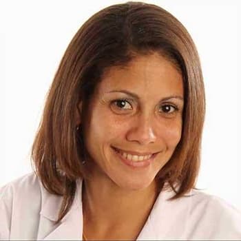 a woman with brown hair and a white shirt.