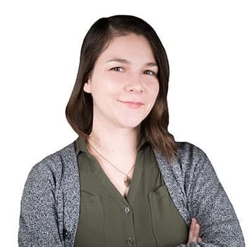 a woman is standing with her arms crossed.