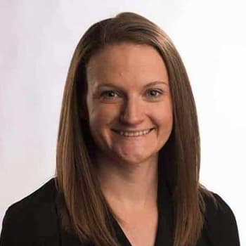 a woman in a black shirt smiling at the camera.